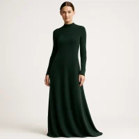 Model wearing dark green maxi knit dress, luxury factory production